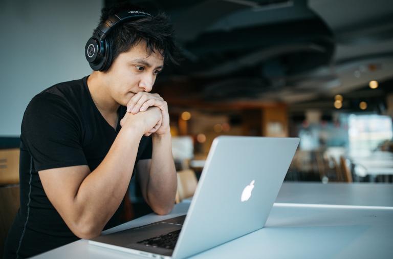 person with headphones on listening to a presentation