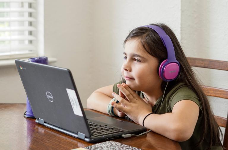 Child learning virtually on a laptop