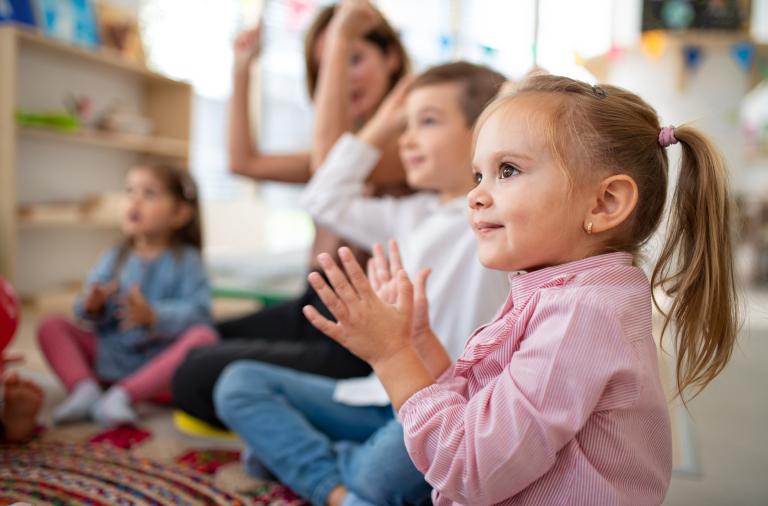 children sat on floor singing