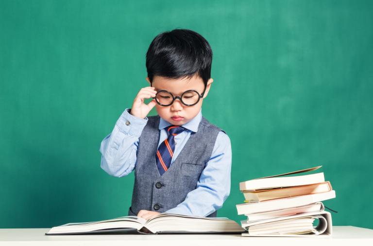 Studious young child with books