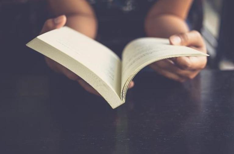 person holding book open