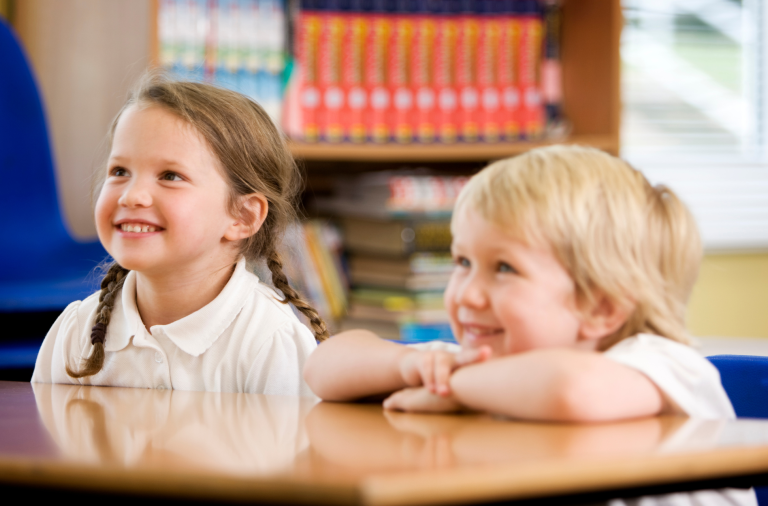 Two young people sitting at a desk