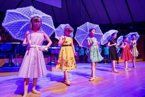 Children dancing with parasols