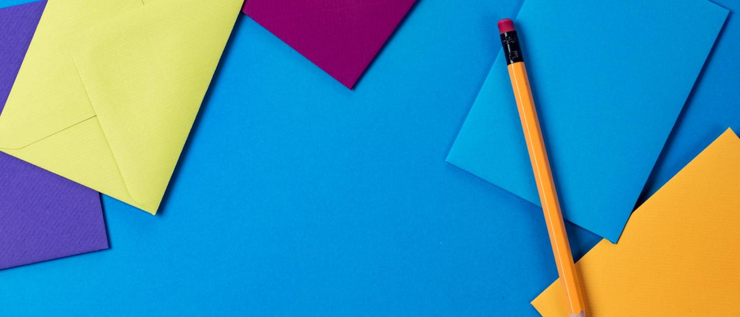 multi-coloured envelopes arranged on a blue background