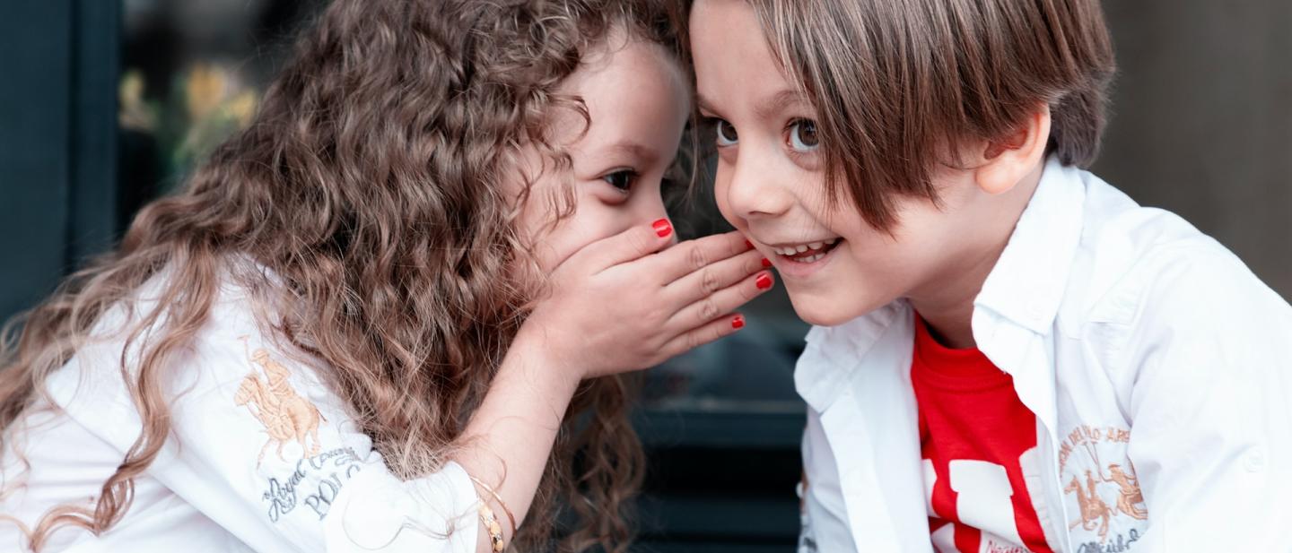 a boy and girl talking together