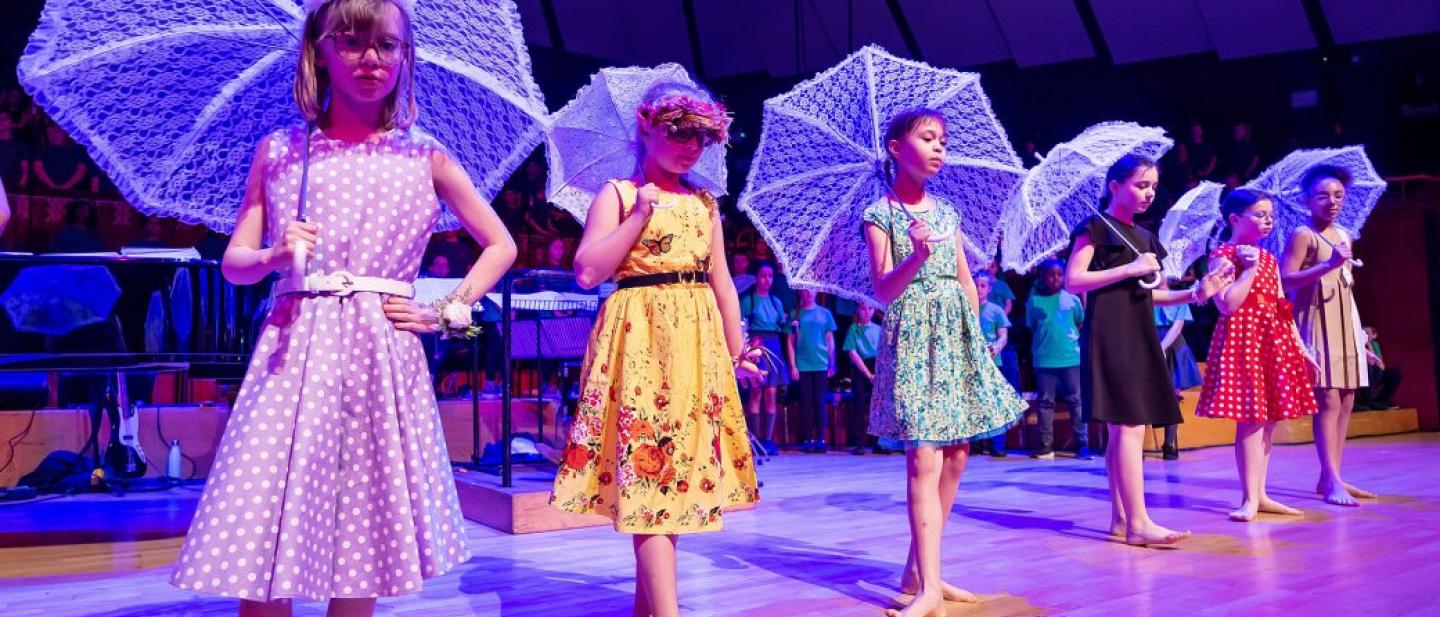 Children dancing with parasols