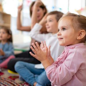 children sat on floor singing