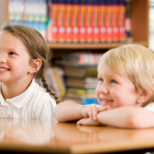 Two young people sitting at a desk